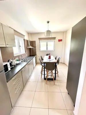 a kitchen with a table and chairs in a room at Villa Papagiorgio Luxury and Harmony in Gennadi