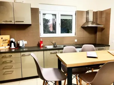 a kitchen with a table and chairs and a sink at Villa Papagiorgio Luxury and Harmony in Gennadi