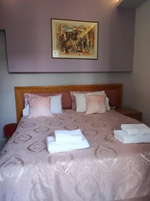 a bedroom with a bed with two towels on it at N E P center Hotel Rodos in Rhodes Town