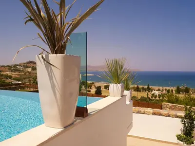 a large white vase sitting on a wall next to a pool at Luxury Villa Eos in vlicha