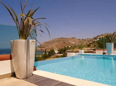 a villa with a swimming pool with a potted plant at Luxury Villa Eos in vlicha