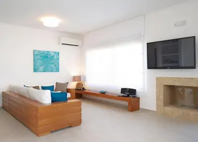 a living room with a couch and a fireplace at Luxury Villa Eos in vlicha