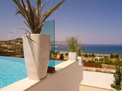 a large white vase sitting on a wall next to a pool at Luxury Villa Eos in vlicha