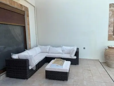 a living room with a couch and a coffee table at Luxury Villa Delfini in Líndos