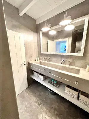 a bathroom with a sink and a mirror at Aetheria traditional house in Koskinou