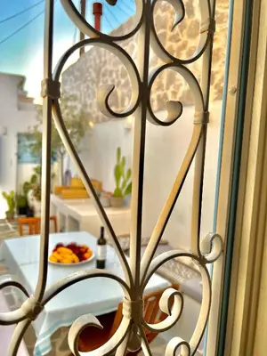 a iron gate with a plate of food on a table at Aetheria traditional house in Koskinou