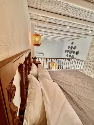 a bedroom with a large bed with white pillows at Aetheria traditional house in Koskinou