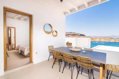 a kitchen and dining room with a table and chairs at Lindian Ethos in Líndos