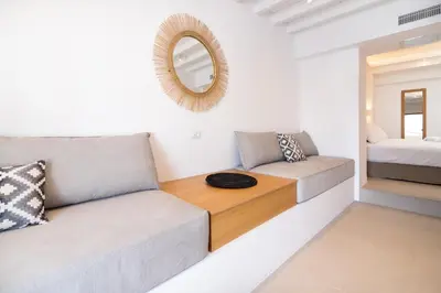 a living room with a couch and a mirror at Lindian Ethos in Líndos