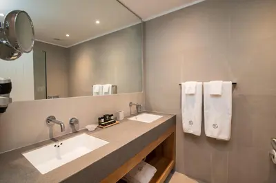 a bathroom with two sinks and a large mirror at Lindian Ethos in Líndos