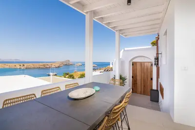 a dining room with a table and a view of the ocean at Lindian Ethos in Líndos