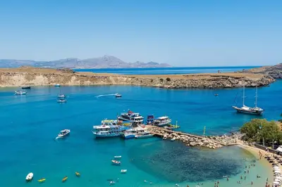 a group of boats are docked in a harbor at Lindian Ethos in Líndos