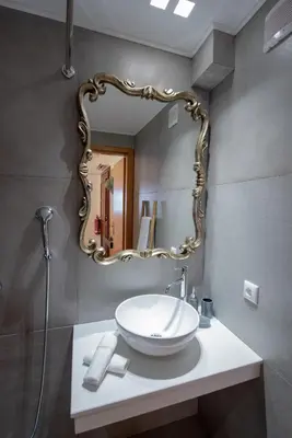 a bathroom with a white sink and a mirror at IN Lindos in Líndos