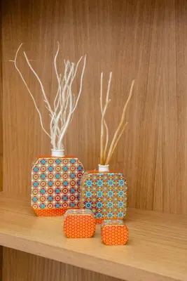 three vases sitting on top of a wooden shelf at IN Lindos in Líndos