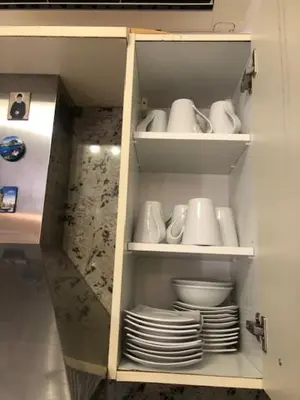 a cabinet filled with plates and cups and bowls at Luxury Villa Ioannis in Líndos