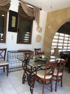 a dining room with a glass table and chairs at Luxury Villa Ioannis in Líndos