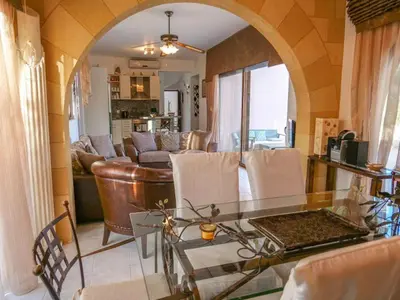 a living room with a glass table and a couch at Luxury Villa Ioannis in Líndos
