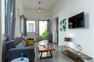a living room with a couch and a table at Rose Central Master Bedroom Apartment in Rhodes Town