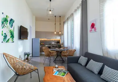 a living room with a couch and a table at Rose Central Master Bedroom Apartment in Rhodes Town