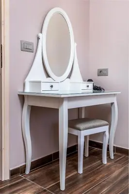 a dressing table with a mirror and a stool at BIBLIOTHEQUE in Rhodes Town