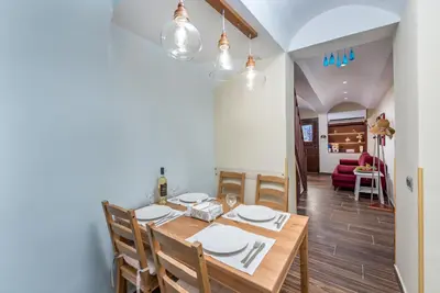 a dining room with a wooden table and chairs at BIBLIOTHEQUE in Rhodes Town