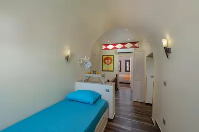 a small room with a bed and a hallway at BIBLIOTHEQUE in Rhodes Town