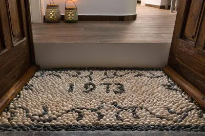 a door mat with the word exit spelled out on the floor at Casa Pietra Lindos Luxury Traditional House in Líndos