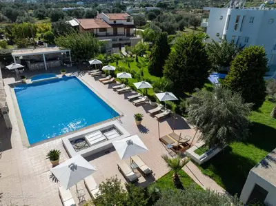 an overhead view of a swimming pool with chairs and umbrellas at Evita in Faliraki