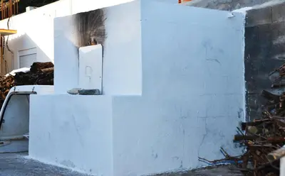 a white wall with a candle on top of it at George's Studios in Archangelos