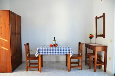 a table with a blue and white checkered table cloth at George's Studios in Archangelos