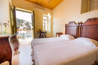 a bedroom with a large bed and a window at Thea in Symi