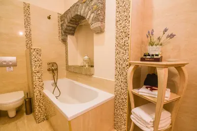 a bathroom with a tub and a toilet and a sink at Thea in Symi