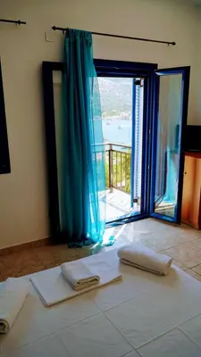a room with a bed with two towels on it at Irene Double Apartment Anoi in Symi