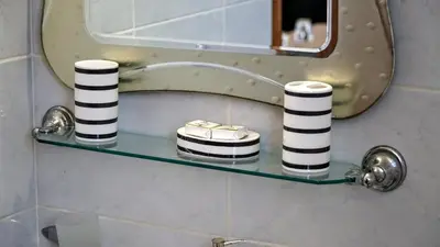 a glass shelf in a bathroom with a mirror at Irene Double Apartment Anoi in Symi