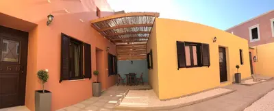 a courtyard of a building with a wooden ceiling at Apartments in the center marasia in Rhodes Town