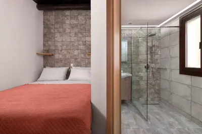 a bedroom with a bed and a glass shower at Apartments in the center marasia in Rhodes Town