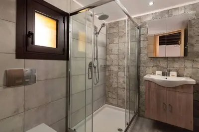 a bathroom with a glass shower and a sink at Apartments in the center marasia in Rhodes Town