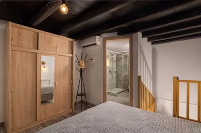 a bedroom with a bed and a door to a bathroom at Apartments in the center marasia in Rhodes Town