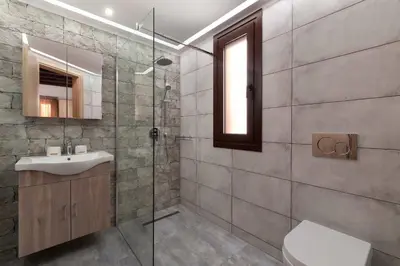 a bathroom with a sink and a glass shower at Apartments in the center marasia in Rhodes Town