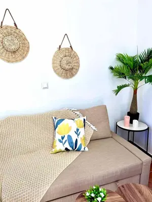 a living room with a couch and a plant at Casa De La Sera in Rhodes Town