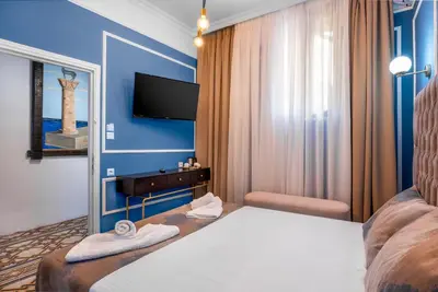 a hotel room with a bed and a tv at Casa De La Sera in Rhodes Town