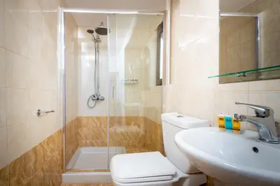 a bathroom with a shower and a toilet and a sink at Casa De La Sera in Rhodes Town