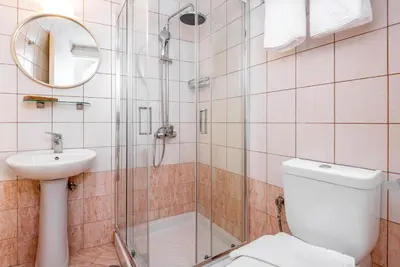 a bathroom with a shower and a toilet and a sink at Casa De La Sera in Rhodes Town