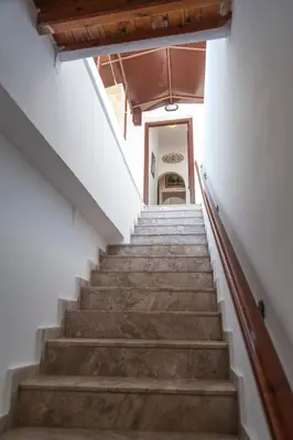 a stairway leading up to a room with a stair case at Stavros Pension in Rhodes Town