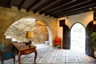 an archway in a room with a table and chairs at Mystic Hotel - Adults only in Rhodes Town