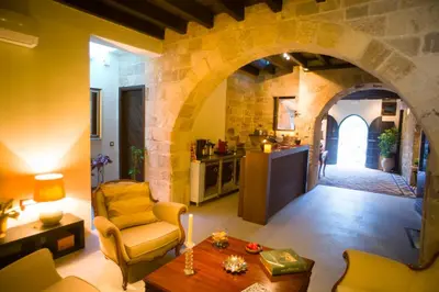 a living room with an archway and a kitchen at Mystic Hotel - Adults only in Rhodes Town