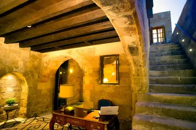 a room with a staircase and a table with a laptop at Mystic Hotel - Adults only in Rhodes Town