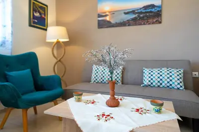 a living room with a table and a couch at Mare Blu 2 on the beach in Gennadi