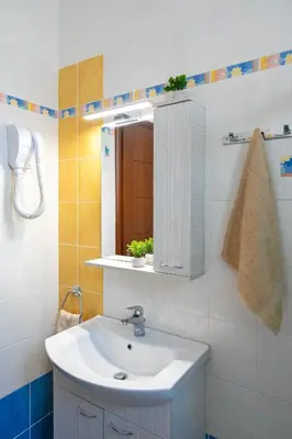 a bathroom with a sink and a mirror at Mare Blu 2 on the beach in Gennadi