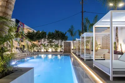 a swimming pool in a hotel at night at Casa Stavris in Faliraki